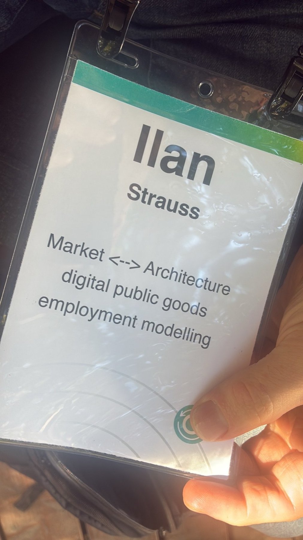 An attendee badge reading: Market to Architecture, digital public goods, employment modeling